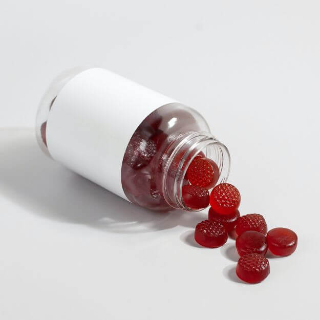 generic red collagen gummy spilled out of bottle