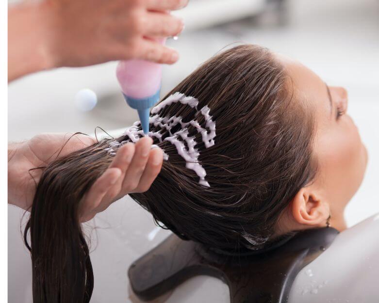 woman with long dark hair getting hair bond shampoo