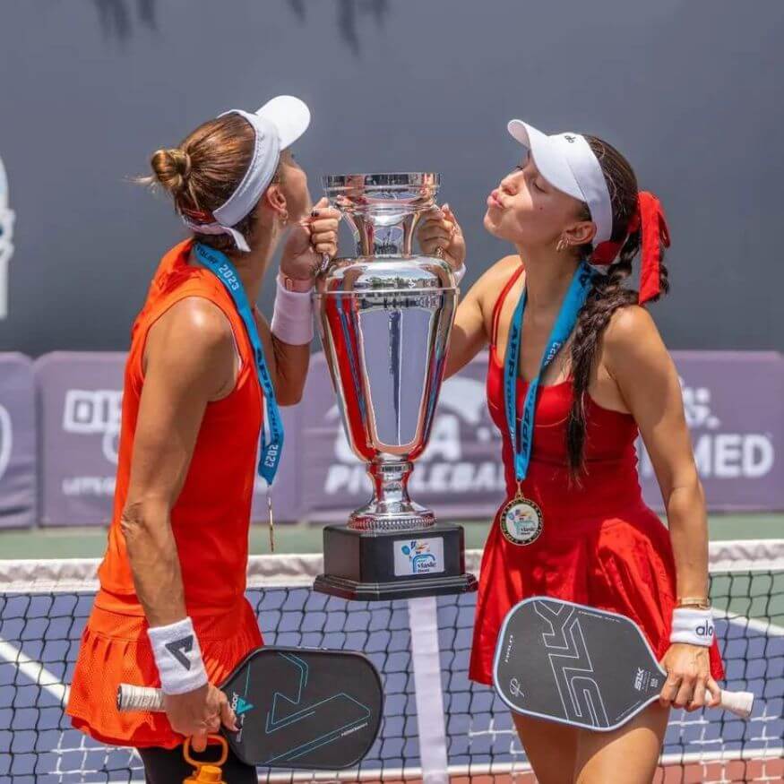doubles pickelball champions kissing trophy