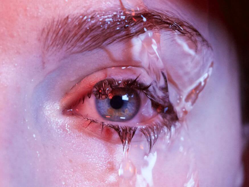 close up of eye and eye lash with water flowing