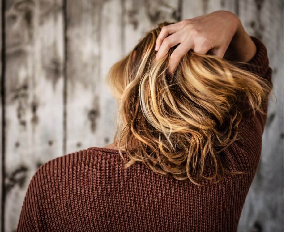 woman running her fingers thru her hair