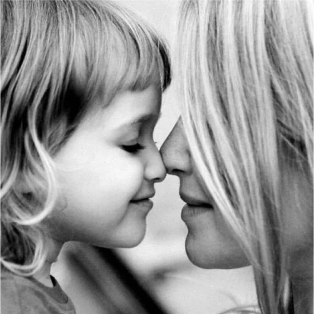 close up on mom and daughter nose to nose