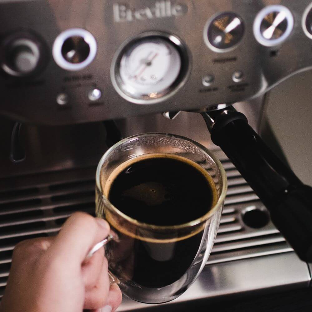 Breville espresso maker with single cup of espresso