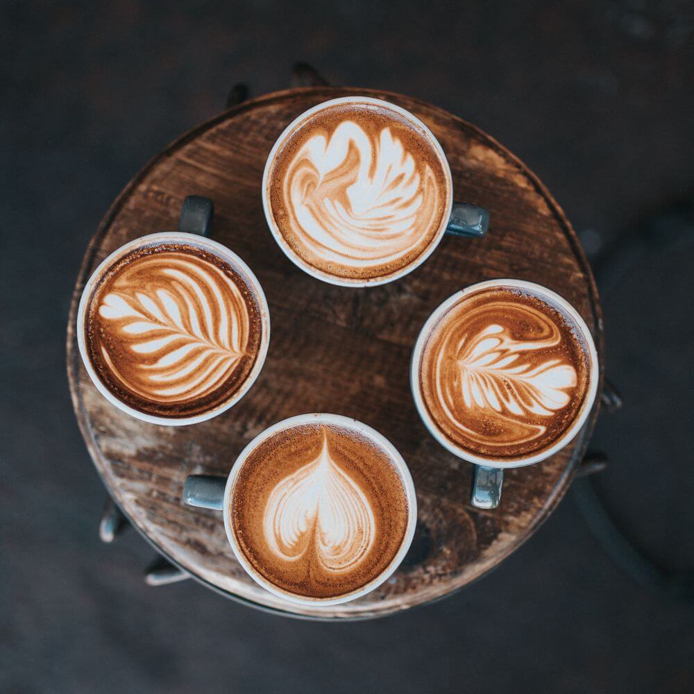 espresso art with 4 decorated espresso drink with hearts and leaves