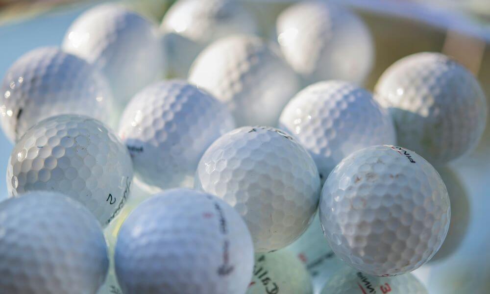 A bunch of white golf balls